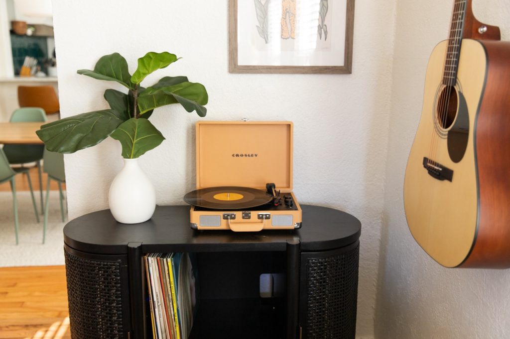Our Airbnb living room featuring a record player and guitar for added character.