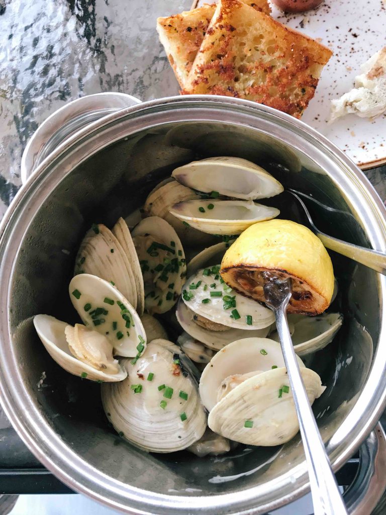 A pot of clams at a seafood restaurant.