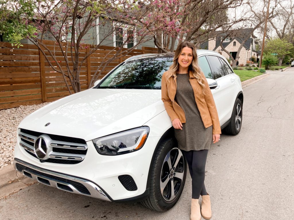 Me standing in front of a white Mercedes that we rented from Turo in Austin, Texas.