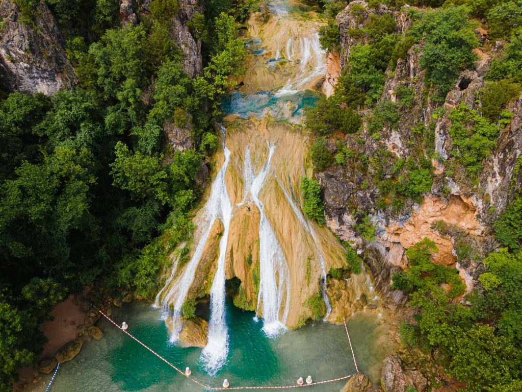 Aerial view of Turner Falls waterfall and the natural swimming pool below.