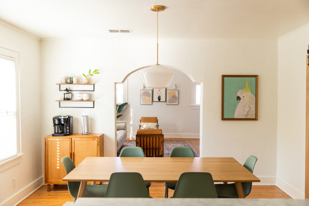 Our Airbnb dining room featuring a stylish dining table, wall art, and a coffee station.