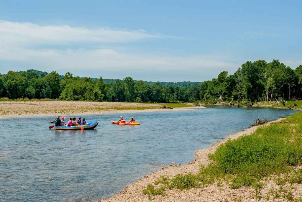 Rafting down a scenic river on a sunny day.