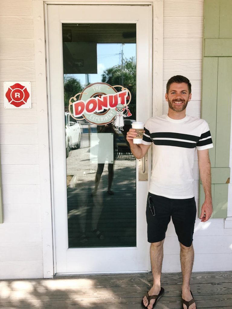 My husband standing in front of The Donut Experiment on Anna Maria Island.