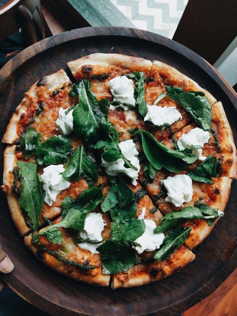 Delicious-looking pizza with mozzarella and basil.