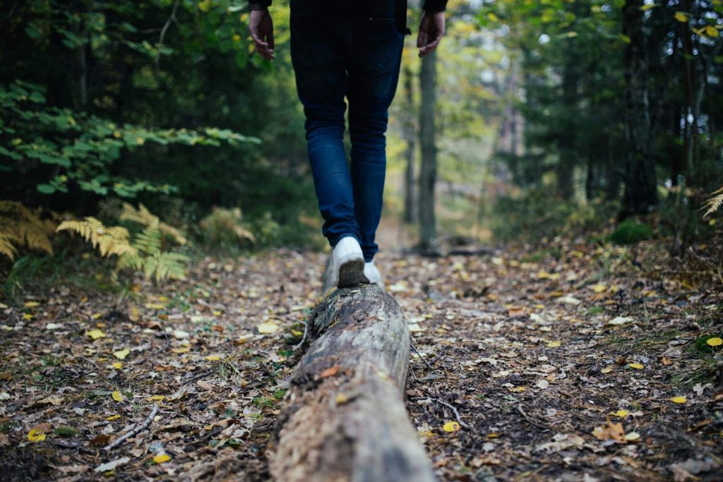 A person hiking through a wooded area.