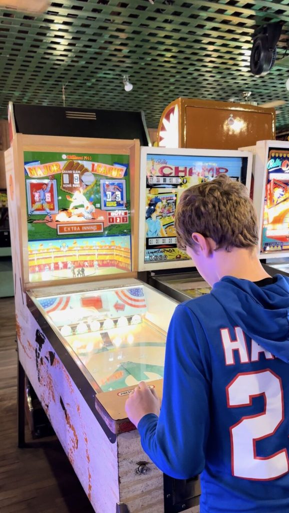 Our son playing pinball at the Penny Arcade in Manitou Springs. This retro baseball pinball machine was his favorite.