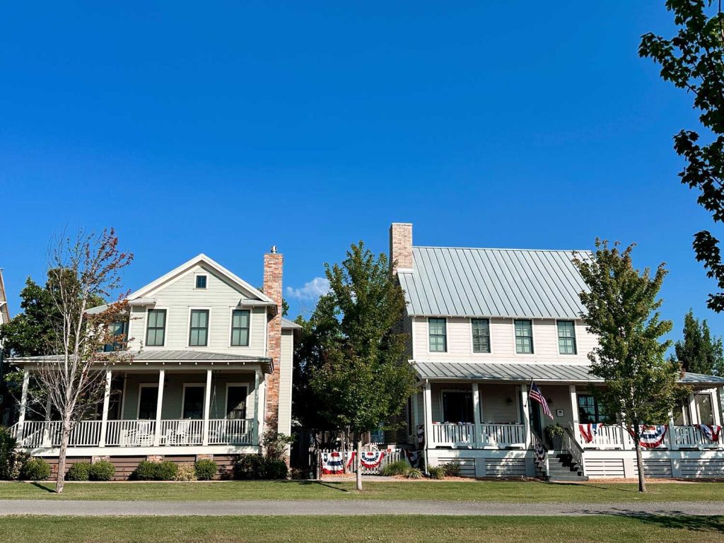 Two beautiful Carlton Landing rental homes with large front porches and a walking trail.