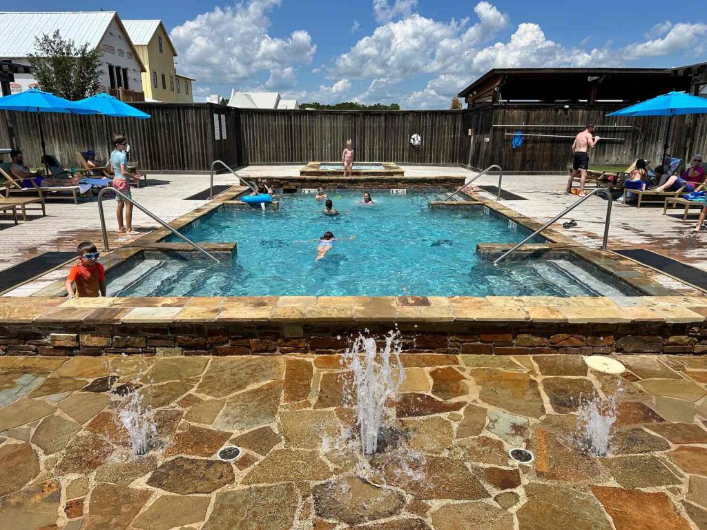 Beautiful swimming pool in Carlton Landing with a hot tub in the back.