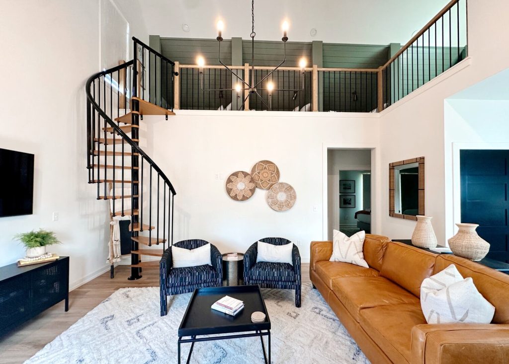 Living room of a Carlton Landing Vacation Rental. This rental has beautiful design, a vaulted ceiling, and a spiral staircase.