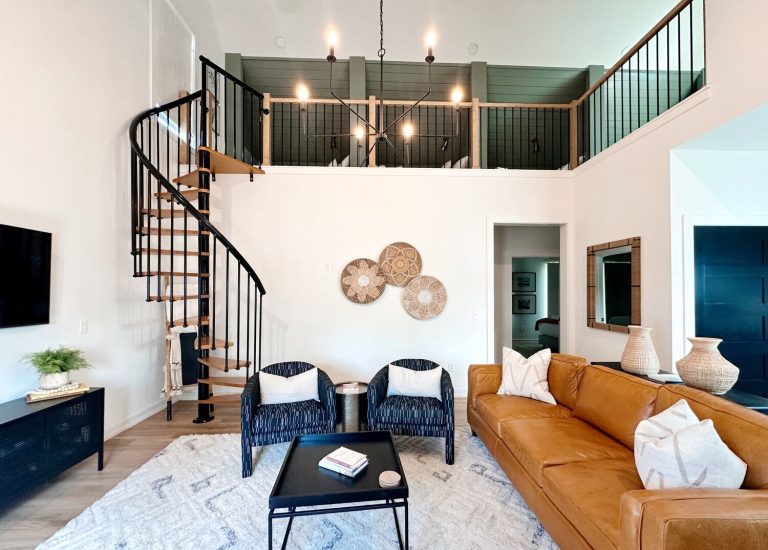 Living room of a Carlton Landing Vacation Rental. This rental has beautiful design, a vaulted ceiling, and a spiral staircase.