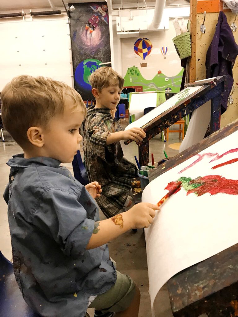 My son painting at Unpluggits Paint and Play.