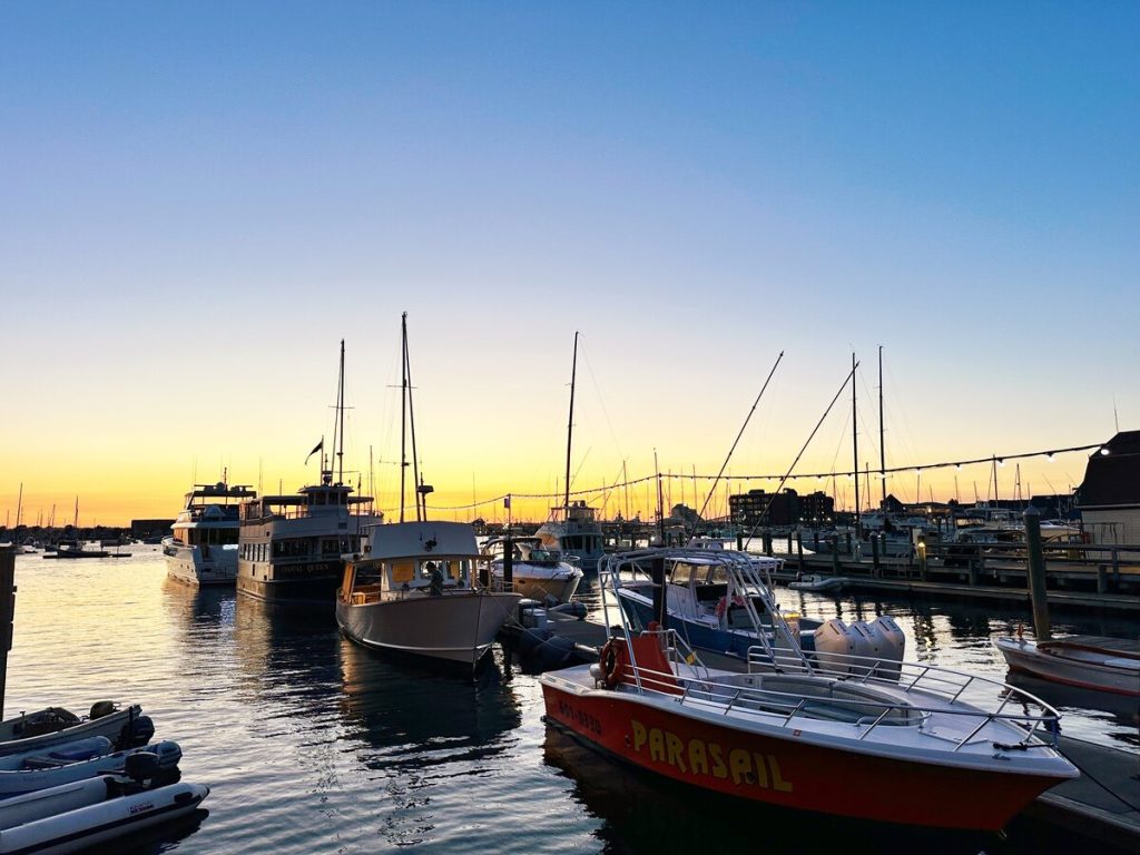Sailboats in the harbor at sunset in Newport, Rhode Island.