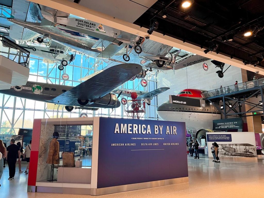 Inside the Air and Space Museum in Washington DC with airplanes suspended from the ceiling.