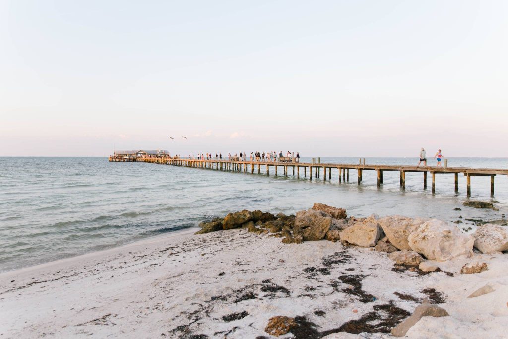 Beautiful pier on Anna Maria Island in Florida with a soft blue sky and beautiful ocean waters.