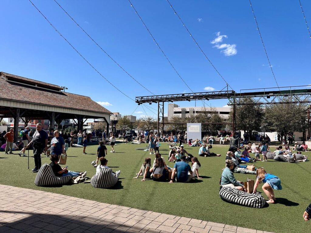 The green turn lawn located in the center of the Silos. It's the perfect place to relax, throw a frisbee, or play a game of cornhole.