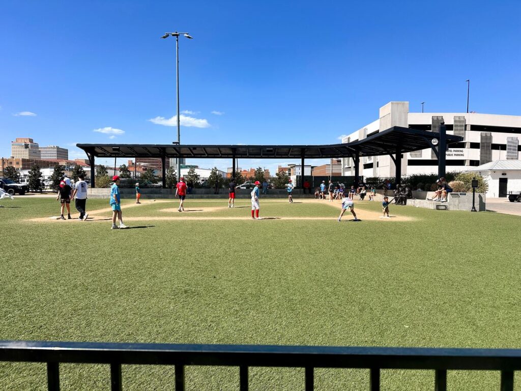 Our kids playing wiffle ball with other kids on the cute turf wiffle ball field. Wiffle ball bats and balls are provided.