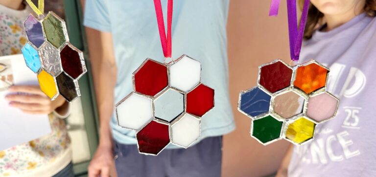 My kids' final products from the stained glass workshop. They each chose their own colors of glass to design their project.