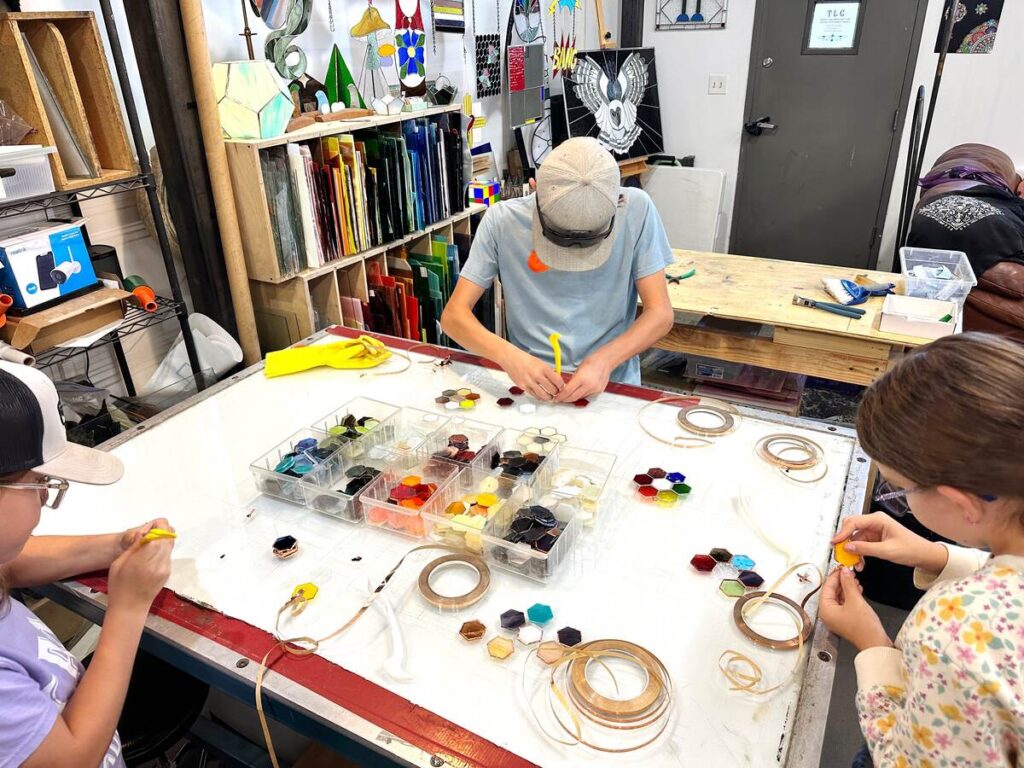 Three of my kids working on their stained glass at the workshop we took in Santa Fe, New Mexico.